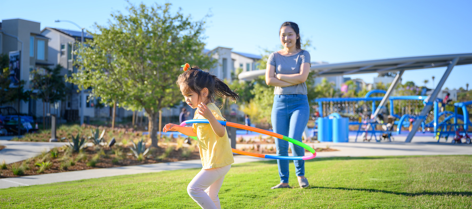 Image of a mother and daughter playing at the park at 3Roots in Sorrento Mesa