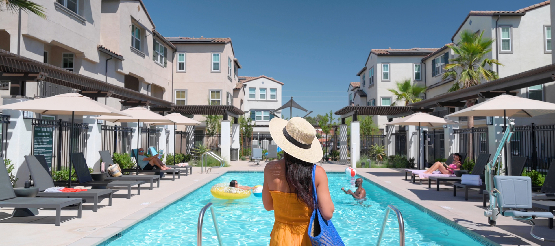 Image of resident walking into the pool at Eclipse