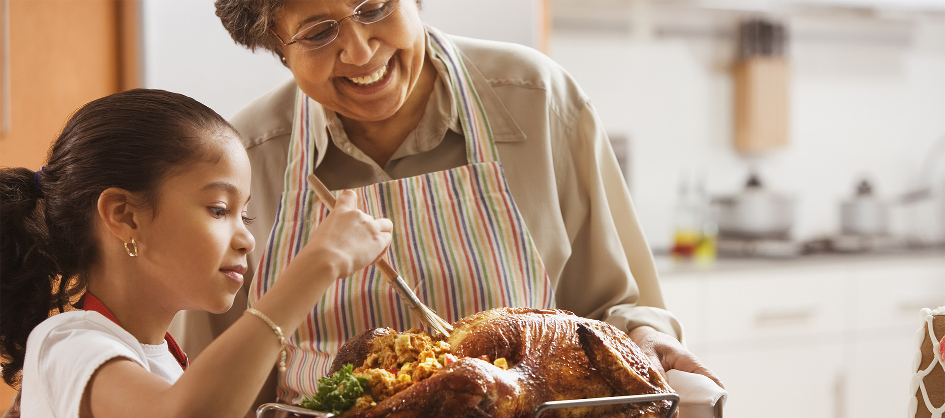 Image of a grandmother and child making Thanksgiving dinner