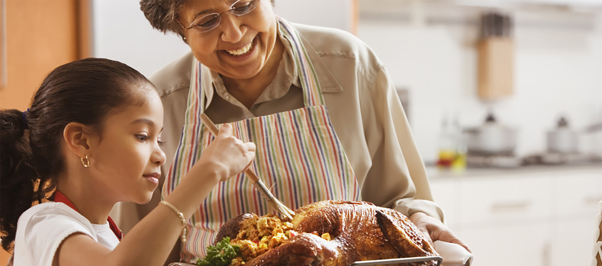 Image of a grandmother and child making Thanksgiving dinner