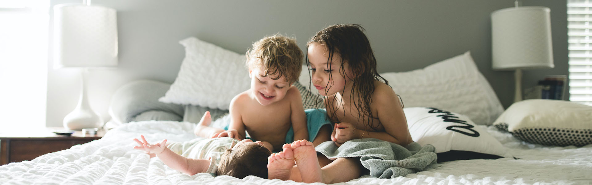 Three kids on bed