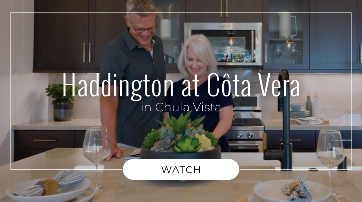 Couple standing in a kitchen within Haddington at Côta Vera enjoying their new home